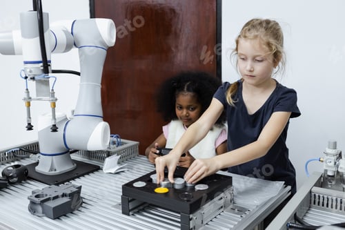 Preview: Children girl caucasoid and girl African American education electronic robotic arm on table at class