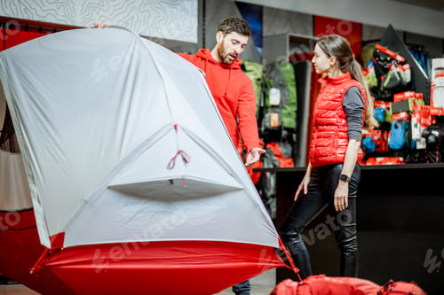 Preview: Salesman with woman client in the sports shop