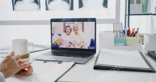 Preview: doctor in white medical uniform with stethoscope using computer laptop talking video conference call