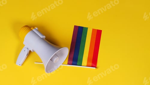 Preview: Megaphone with a pride flag on yellow background.