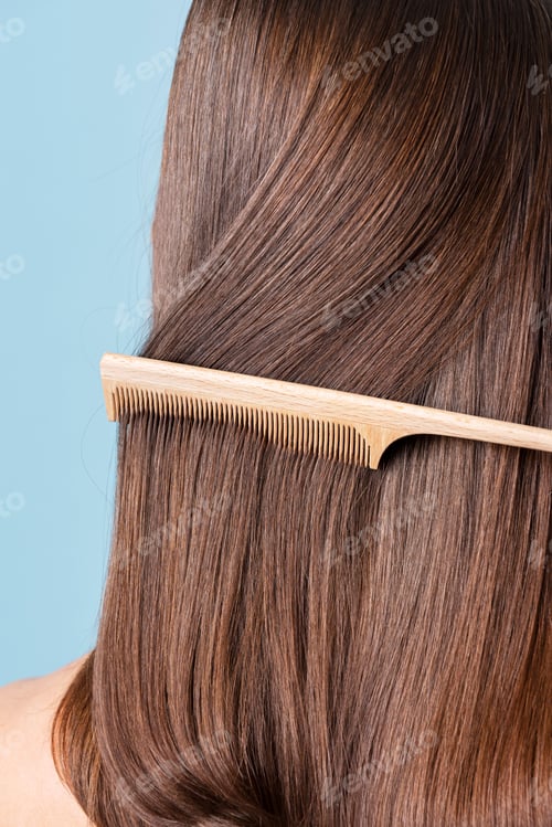 Preview: Woman combing her sleek hair