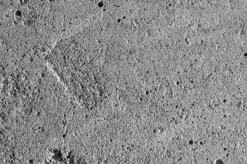 Preview: Uneven old cracked dirty concrete floor texture background.