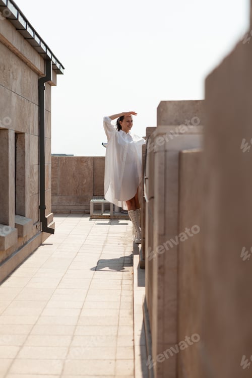 Preview: Caucasian female tourist enjoying looking at metropolitan city landscape