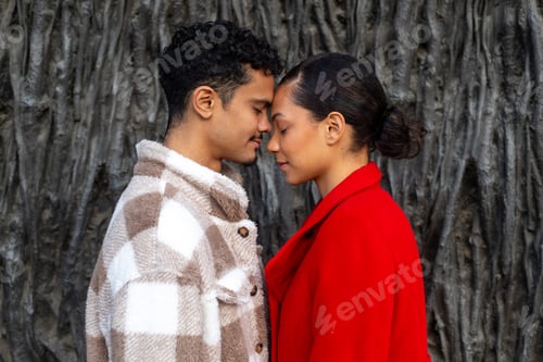 Preview: Young couple sharing intimate moment foreheads together