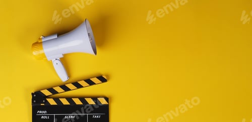 Preview: Clapper board or movie slate and yellow megaphone on yellow background.