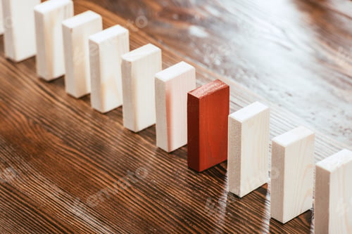 Preview: selective focus of wooden block row with red one on desk
