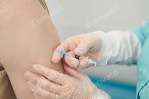 Preview: Man being vaccinated by professional in clinic