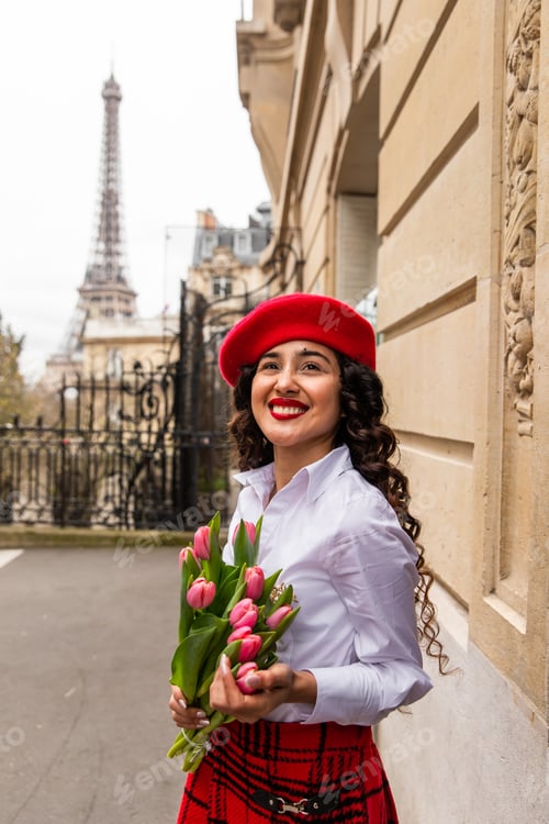 Preview: Selective focus shot of a stylish girl holding a tulips in Paris, France