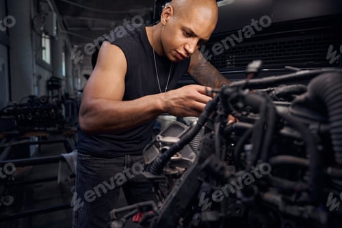 Preview: Serious auto-mechanic going through carburetor, checking serviceability
