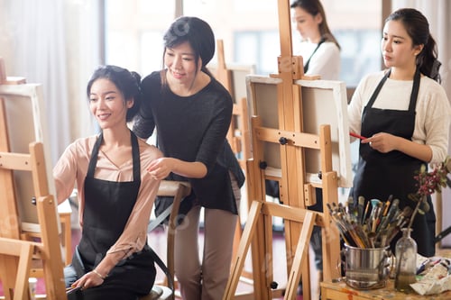 Preview: Art teacher with young women in studio