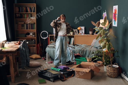 Preview: Caucasian Teenager Girl Packing Suitcase and Organizing Belongings in Bedroom