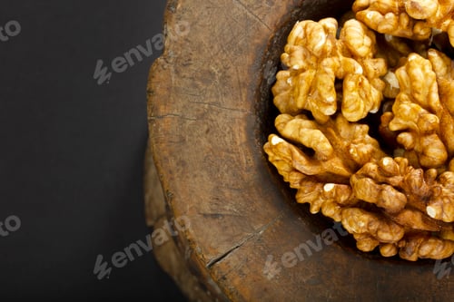 Preview: Walnuts in antique, wooden mortar.