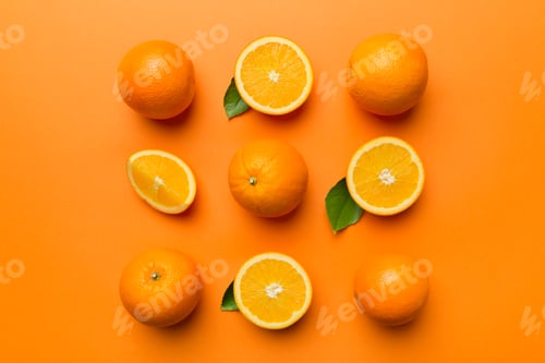 Preview: Fruit pattern of fresh orange slices on colored background. Top view. Copy Space.