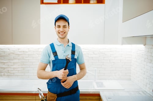 Preview: Smiling Plumber in Overalls Holding a Wrench