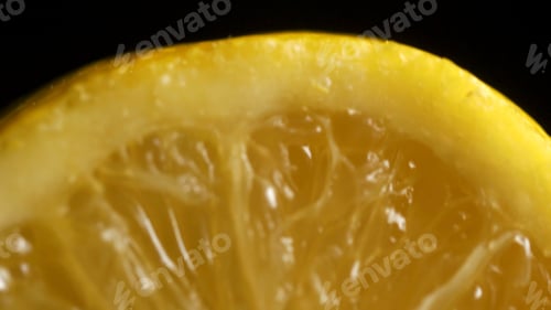 Preview: Lemon sectional on black background. Half lemon on a black background. lemon slice on black isolated