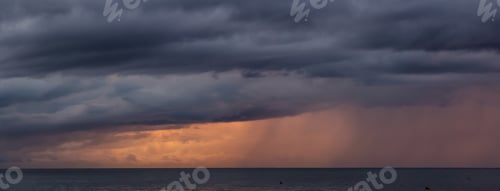 Preview: Cloudscape during a dark, rainy and colorful morning sunrise