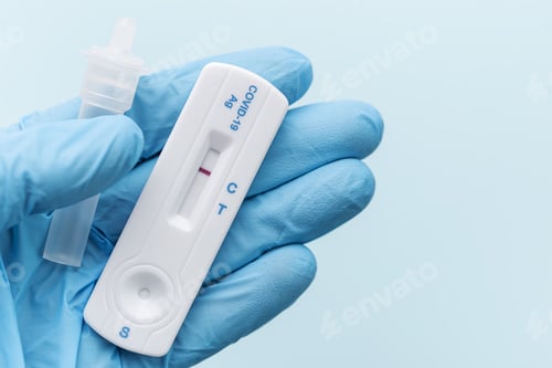Preview: Doctor holding a negative result for COVID-19 with test kit for viral disease.