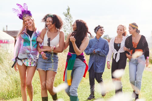 Preview: Female Friends Walking Back To Tent After Outdoor Music Festival