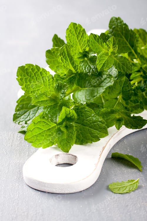 Preview: Fresh mint on white cutting board