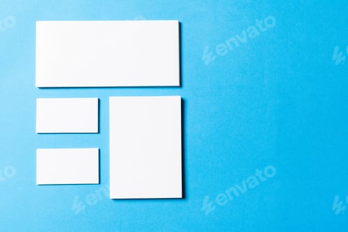 Preview: blank office objects organized for company presentation on blue paper background