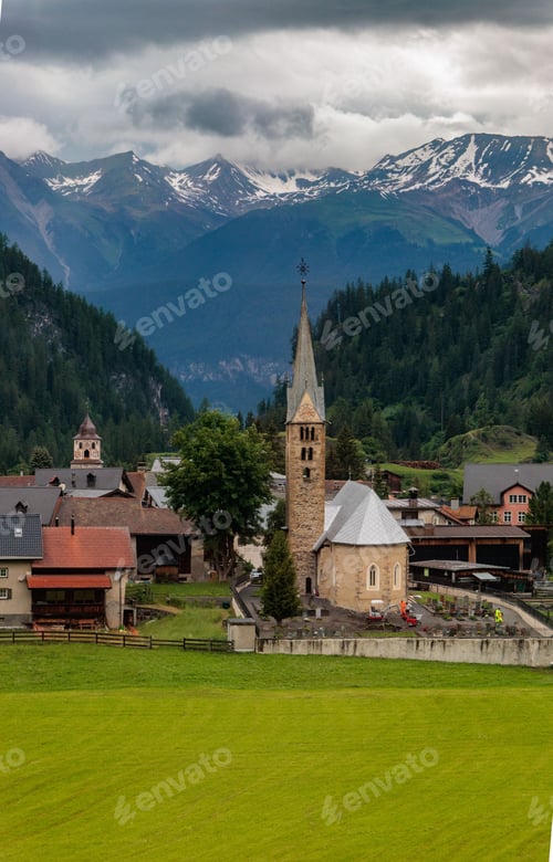 Preview: Reformed Church in Bravuogn in Graubunden with the townscape and mountains in the background