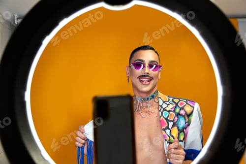Preview: Drag queen with ring light broadcasting live with smartphone