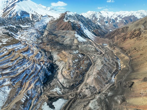 Preview: Massive industrial mining complex carved into a snowy mountain valley