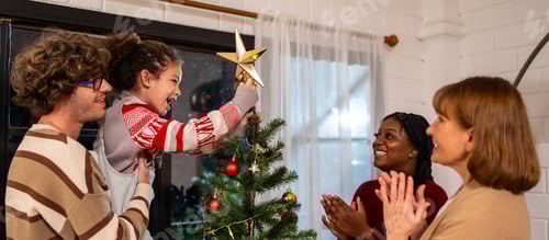 Preview: Attractive family and kid daughter decorating Christmas tree in house.