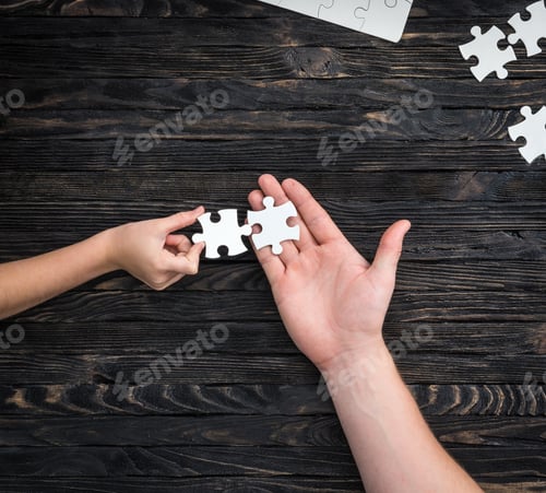 Preview: pieces of white puzzle in hands