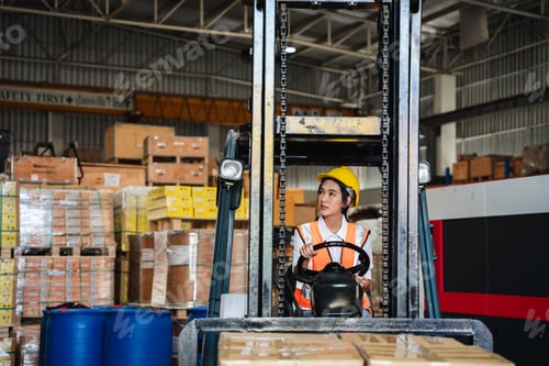 Preview: Portrait of a female worker with a forklift in the warehouse., Industrial and industrial concept.