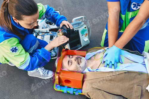 Preview: First aid, ambulance. Paramedics provide first aid to injured man with medical equipment, give