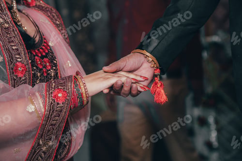 Preview: a man and woman hold hands at a wedding event with a bride holding the hand