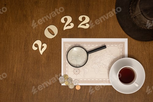 Preview: Flat lay travel composition with numbers 2022 and world map.