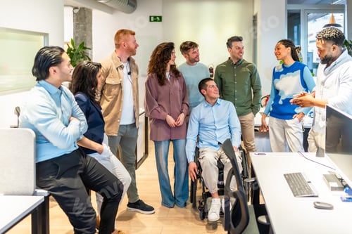 Preview: Diverse business team listening to a project manager in a modern office