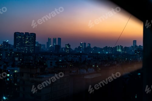 Preview: City skyline at sunset with orange and blue hues, silhouetting skyscrapers