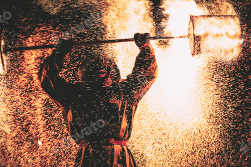 Preview: Fire show at night. Young men stands in front of an audience and