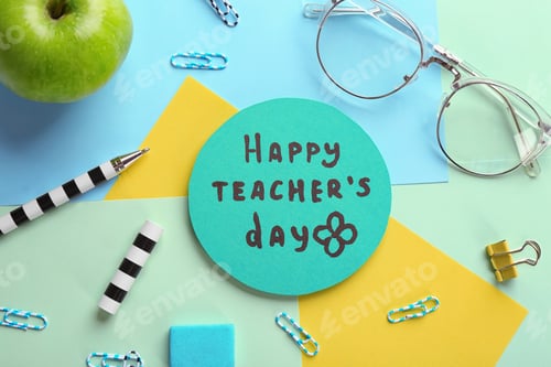 Preview: Paper with inscription HAPPY TEACHER'S DAY and stationery on color background