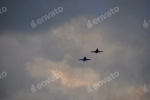 Preview: Two military planes flying overhead.