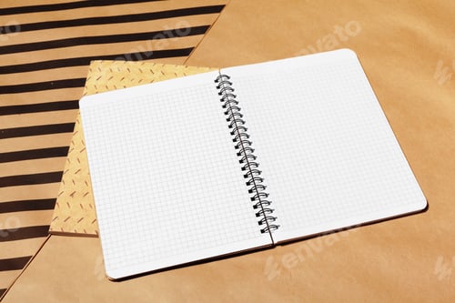 Preview: Open spiral notebook with graph paper on various brown paper backgrounds