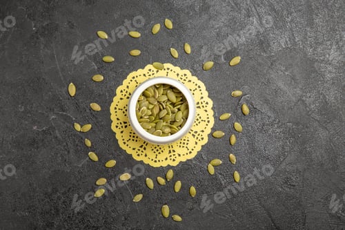 Preview: top view fresh pumpkin seeds on dark background seed color many pumpkin granule