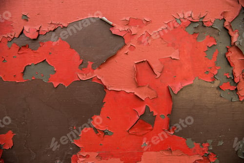 Preview: Full frame texture background of red and flaky peeling paint exposing bare metal with copy space