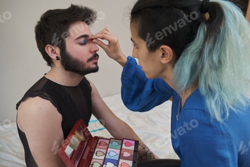Preview: Make-up artist applying eye shadow to a man.