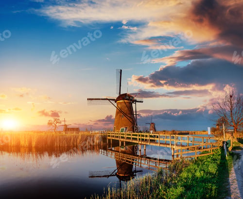 Preview: Colorful spring day with traditional Dutch windmills canal in Ro