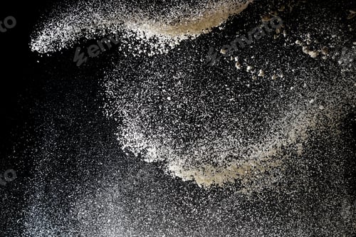 Preview: Flour sifting on a black background. White powder splash isolated on black background