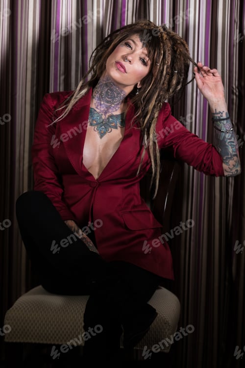 Preview: Beautiful, independent woman with tattoos and dreadlocks