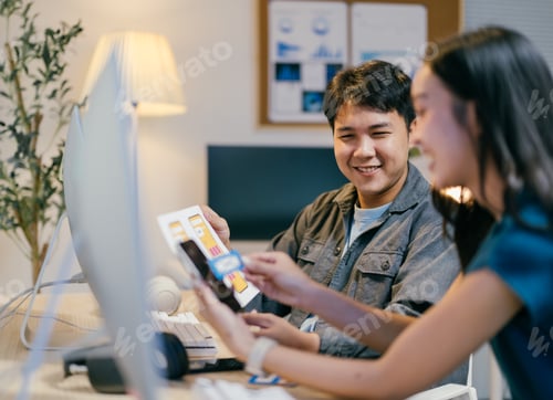 Preview: Two young ui/ux designers are working together in the office, discussing mobile app interface design