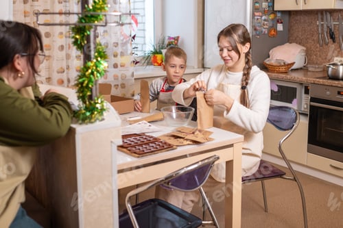 Preview: Friends Preparing Chocolate Candies in Bright Kitchen