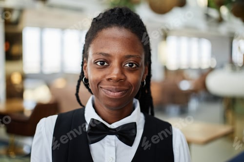 Preview: Portrait of Young Adult Black Woman Smiling While Working as Restaurant Server