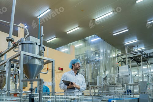 Preview: A factory worker inspects advanced machinery in a modern food production