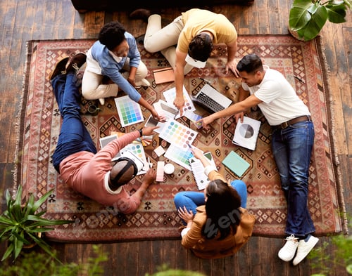 Preview: Teamwork, creative and overhead with a designer team lying on the floor while working on a project.